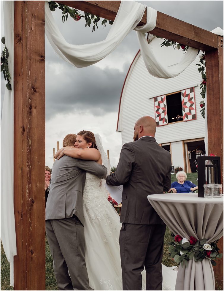 bride and groom at ceremony at wren farm barn